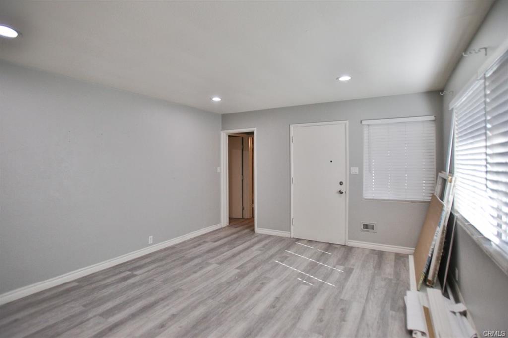 Modern living room with hardwood floors and large windows at 525 W Hampshire Ave